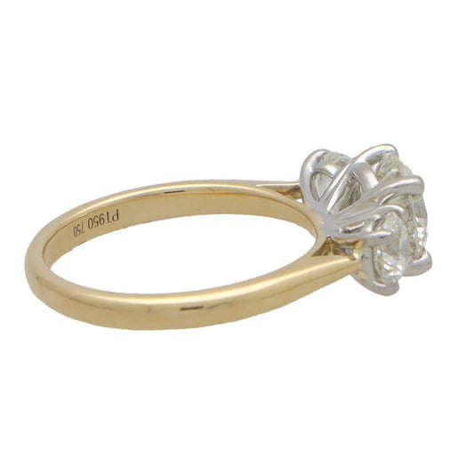 Diamond three stone engagement ring in yellow and white gold.