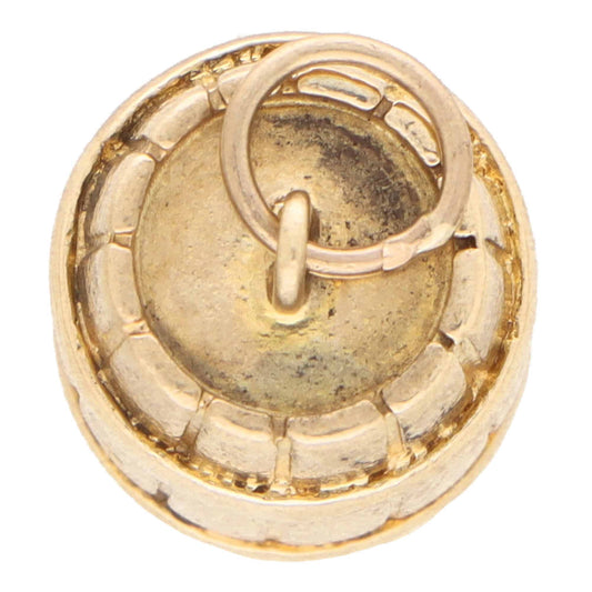 A yellow gold barrel charm, on a white background