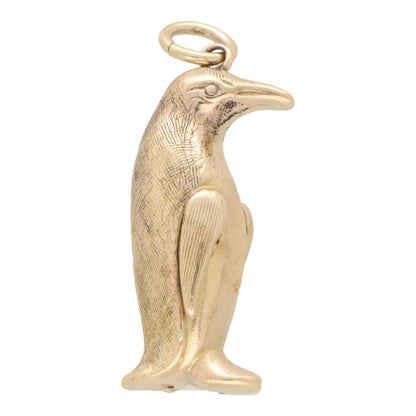A yellow gold penguin charm, on a white background