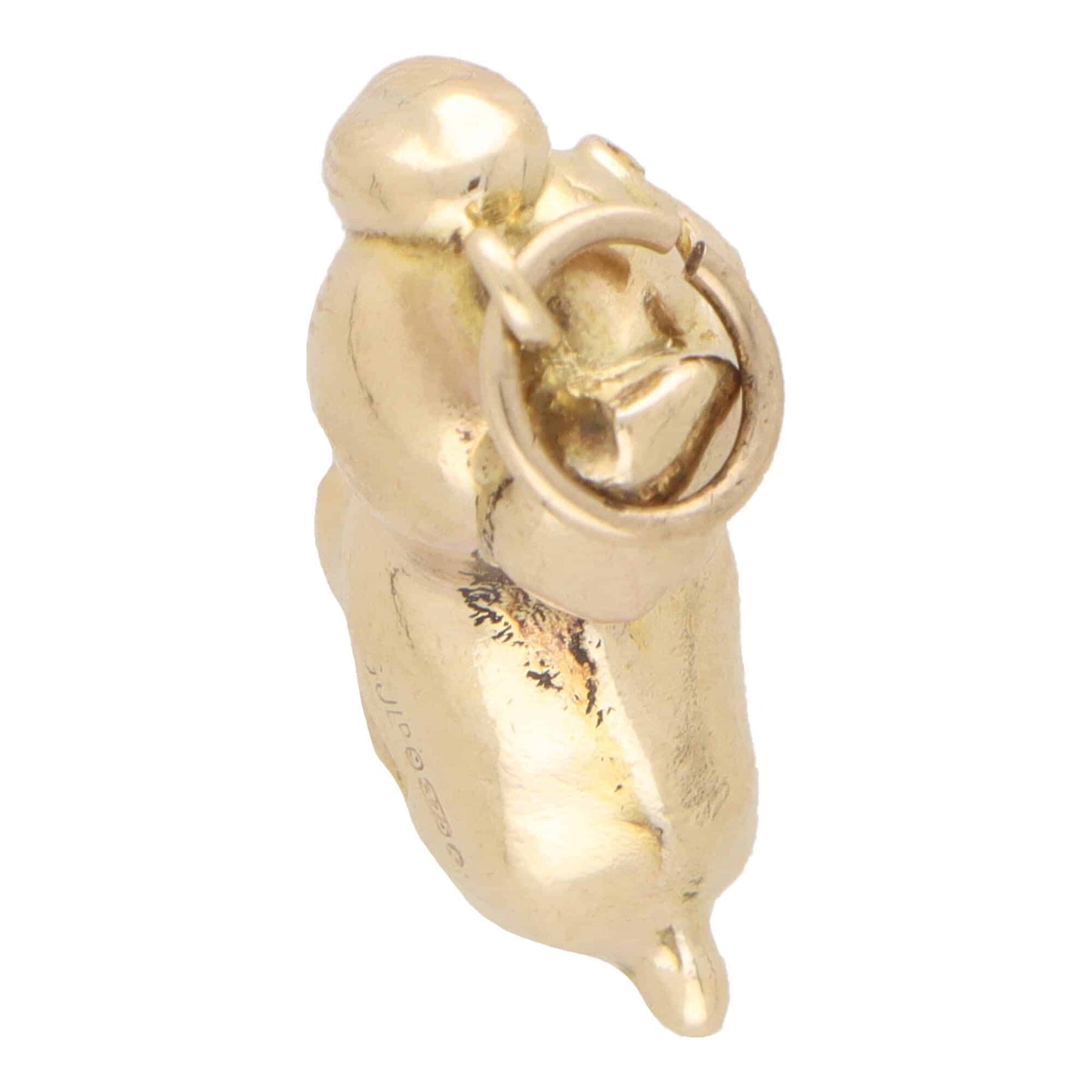 A yellow gold puppy dog charm, on a white background