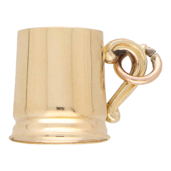 A yellow gold tankard charm, on a white background