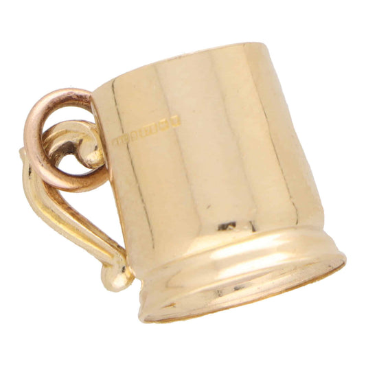 A yellow gold tankard charm, on a white background