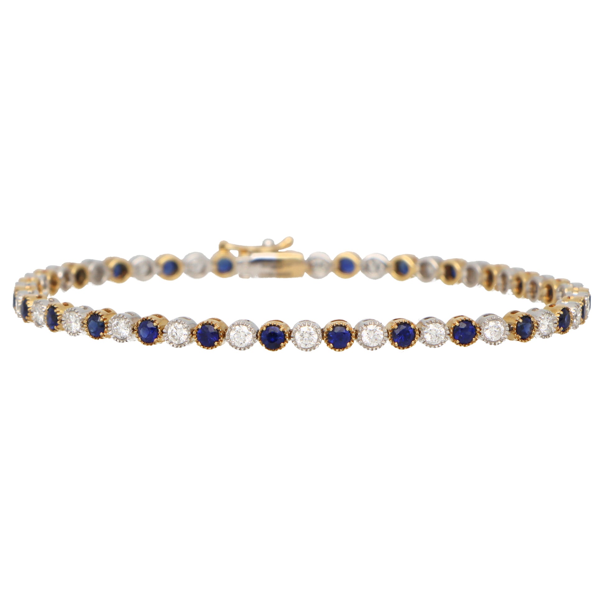 A sapphire and diamond line bracelet in yellow and white gold, on a white background