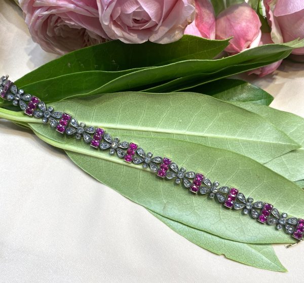 Antique Victorian Ruby and Rose Cut Diamond Bracelet; comprised of butterfly shaped panels set with rose-cut diamonds alternated with bar links set with oval-cut rubies, in silver and gold