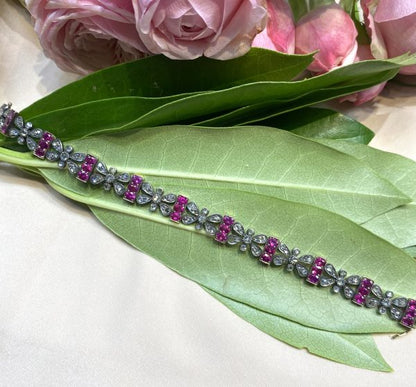 Antique Victorian Ruby and Rose Cut Diamond Bracelet; comprised of butterfly shaped panels set with rose-cut diamonds alternated with bar links set with oval-cut rubies, in silver and gold