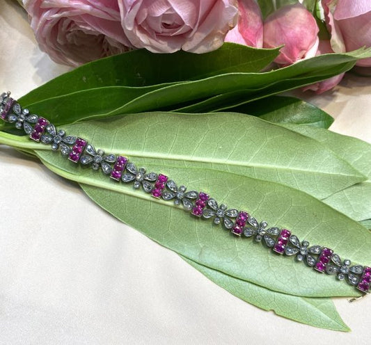 Antique Victorian Ruby and Rose Cut Diamond Bracelet; comprised of butterfly shaped panels set with rose-cut diamonds alternated with bar links set with oval-cut rubies, in silver and gold