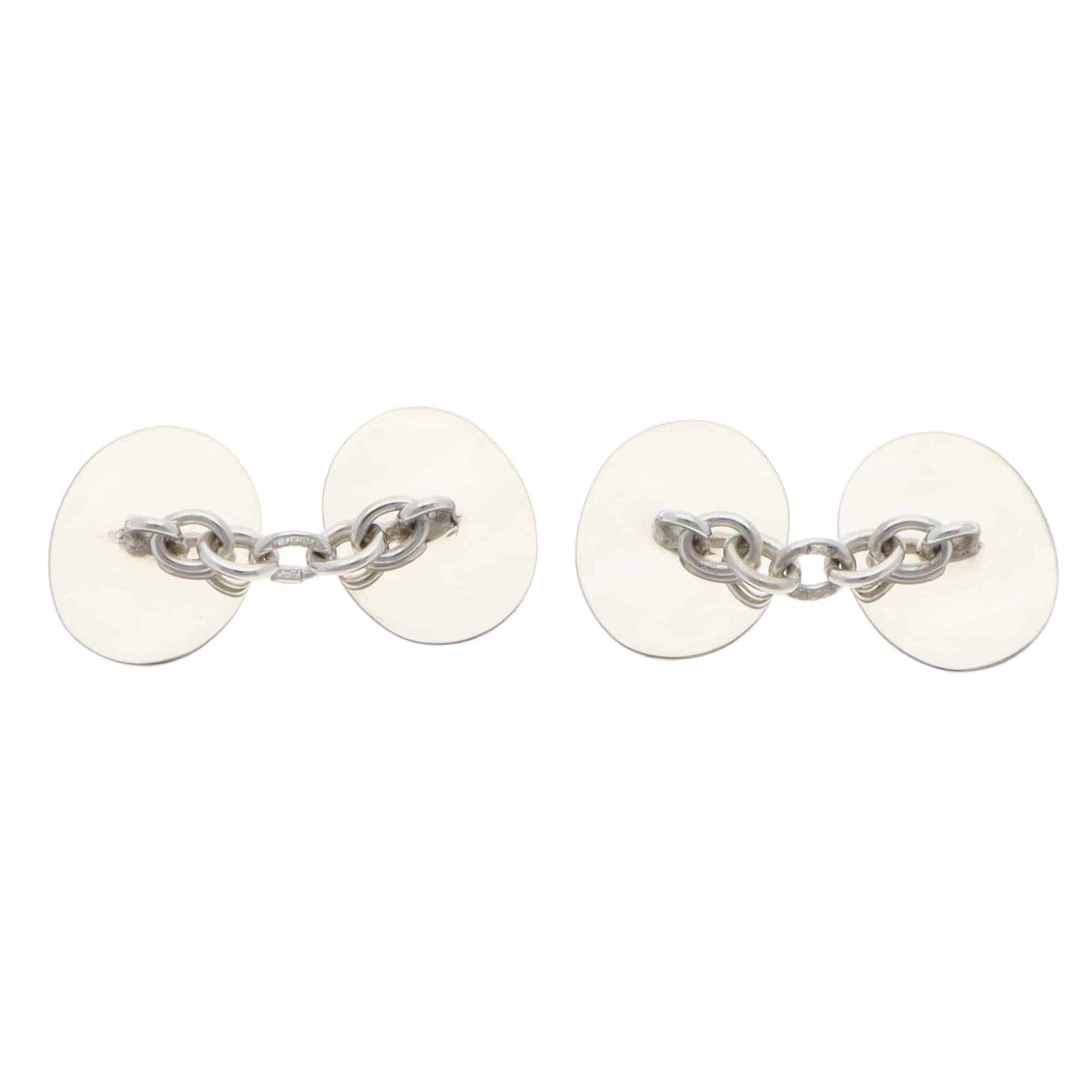 Pair of silver chain cufflinks on a white background