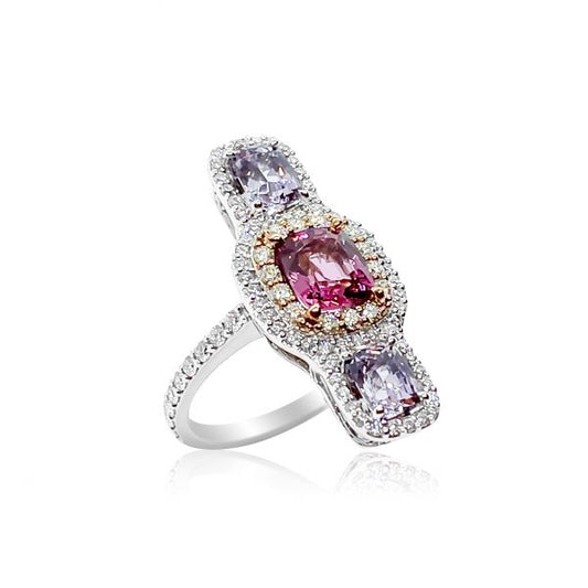 Pink and Lilac Spinel Three Stone Ring with Diamonds; central 1.62ct cushion-shaped pink spinel flanked top and bottom by a cushion-cut lilac spinel, all surrounded by diamonds, in 18ct rose and white gold