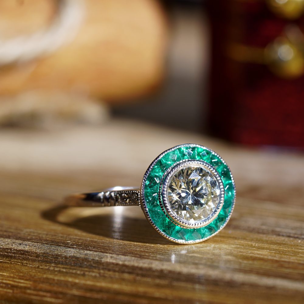 Certified 1ct Diamond and Calibre Emerald Target Cluster Engagement Ring in Platinum