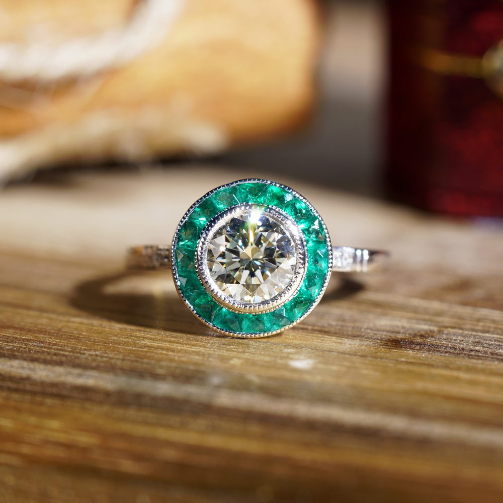 Certified 1ct Diamond and Calibre Emerald Target Cluster Engagement Ring in Platinum