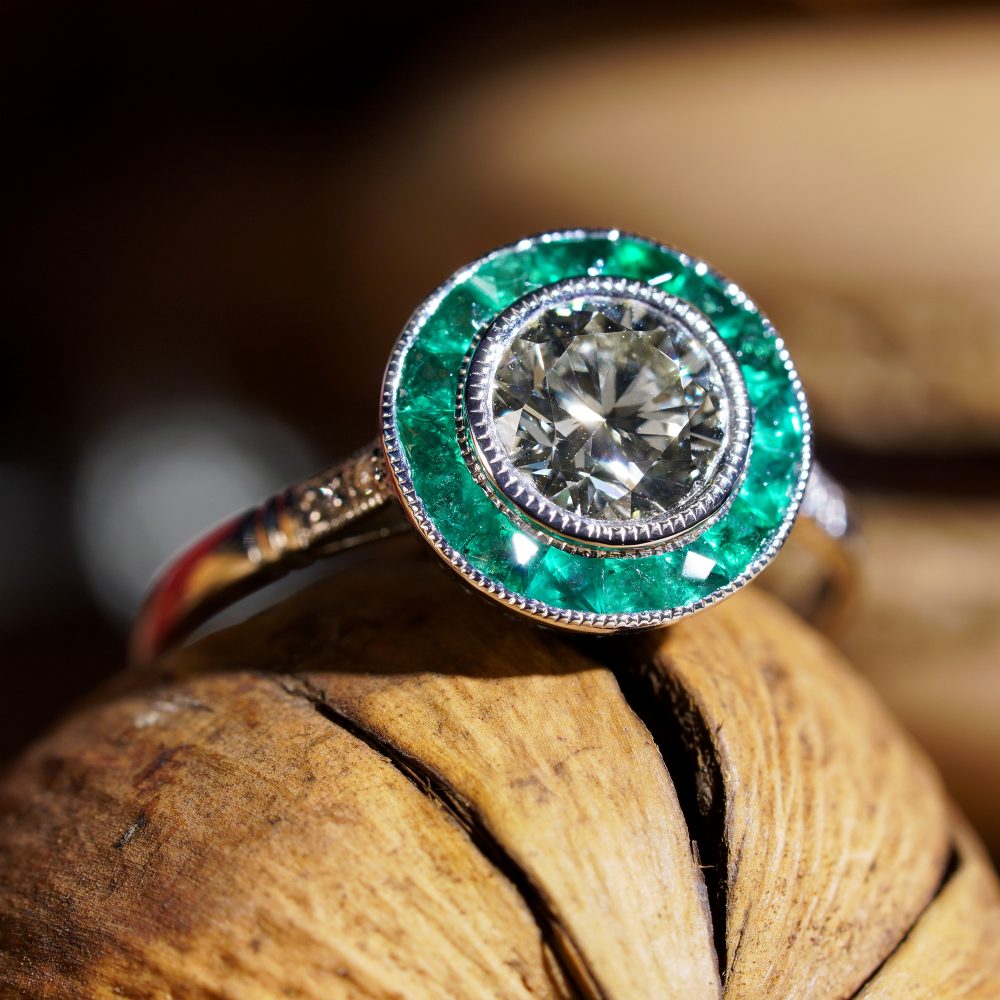 Certified 1ct Diamond and Calibre Emerald Target Cluster Engagement Ring in Platinum