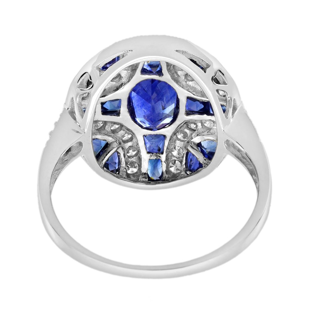 1.10ct Oval Sapphire and Diamond Geometric Cluster Dress Ring, 1.10ct oval-cut sapphire adorned by 1.25cts French cut sapphires with round brilliant diamond lines on each corner in 18ct white gold with millegrain edging