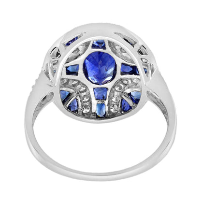 1.10ct Oval Sapphire and Diamond Geometric Cluster Dress Ring, 1.10ct oval-cut sapphire adorned by 1.25cts French cut sapphires with round brilliant diamond lines on each corner in 18ct white gold with millegrain edging
