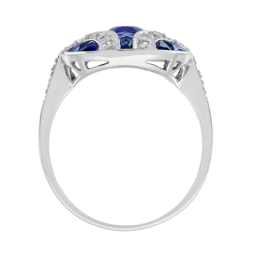 1.10ct Oval Sapphire and Diamond Geometric Cluster Dress Ring, 1.10ct oval-cut sapphire adorned by 1.25cts French cut sapphires with round brilliant diamond lines on each corner in 18ct white gold with millegrain edging