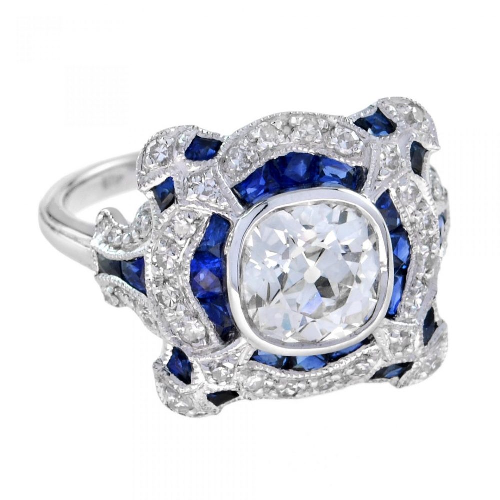 Art Deco Style GIA Certified 1.52ct Diamond and Sapphire Dress Ring; central 1.52ct old mine-cut diamond is surrounded by French-cut blue sapphires and single-cut diamonds, in 18ct white gold, with GIA certificate