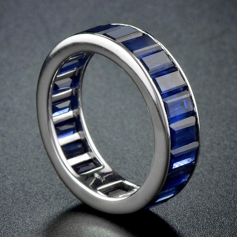 Baguette Sapphire Full Eternity Ring in 18ct Gold; set with twenty-two vertically channel-set baguette-cut sapphires totalling 14.3 carats. Made to order