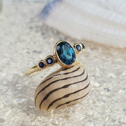 1.15ct Oval Blue Topaz and Sapphire Five Stone Ring