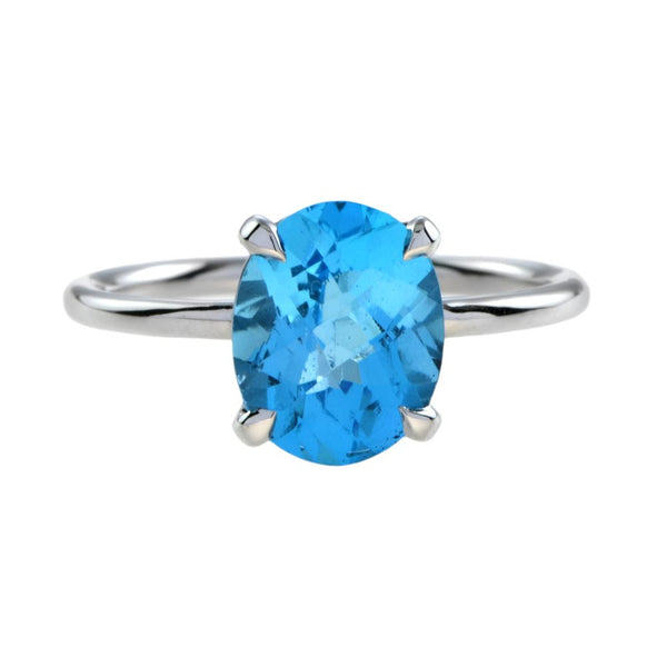 3.50ct Oval Swiss Blue Topaz Solitaire Engagement Ring; 3.50 carat oval blue topaz four-claw set and mounted to a plain 9ct white gold band