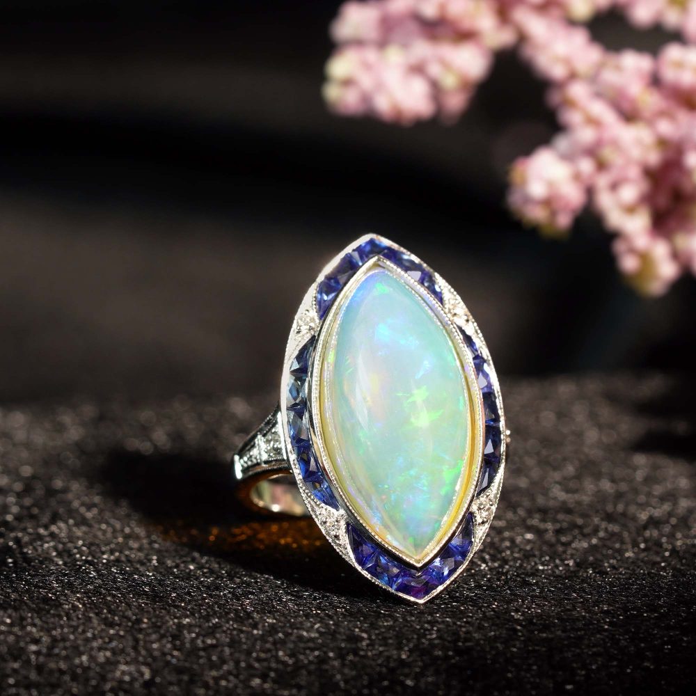 6.55ct Marquise Opal with Sapphire and Diamond Cluster Navette Ring