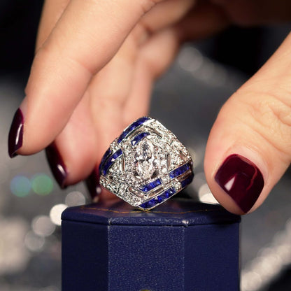 GIA 1ct Marquise Diamond and Sapphire Cluster Dress Ring, D Colour Internally Flawless, GIA Certified D IF 1ct marquise-cut diamond centrally set to tapered navette surround studded with sparkling diamonds accented with lines of French cut blue sapphires in 18ct white gold with a GIA certificate