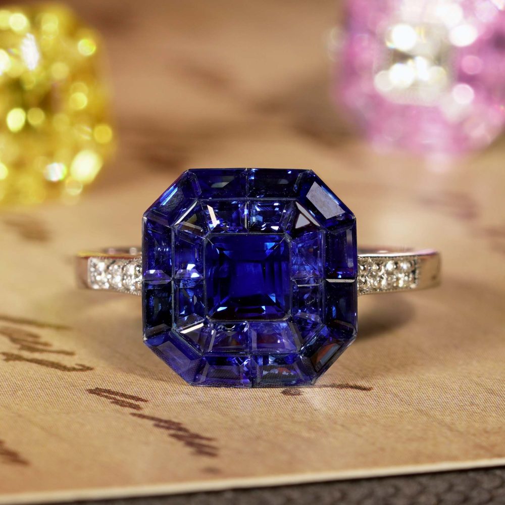 Octagonal Sapphire Cluster Solitaire Engagement Ring, 5.72cts multi asscher and calibre cut sapphires arranged in invisible setting to produce an octagonal shaped design