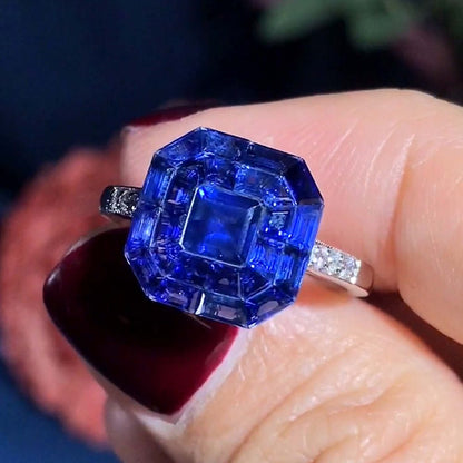 Octagonal Sapphire Cluster Solitaire Engagement Ring, 5.72cts multi asscher and calibre cut sapphires arranged in invisible setting to produce an octagonal shaped design