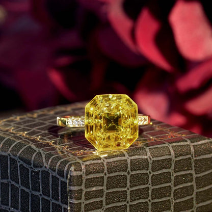 Yellow Sapphire Octagonal Cluster Solitaire Engagement Ring, 5.27cts yellow sapphires arranged in an invisible setting to produce an octagonal shaped design in 14ct yellow gold with diamond set shoulders