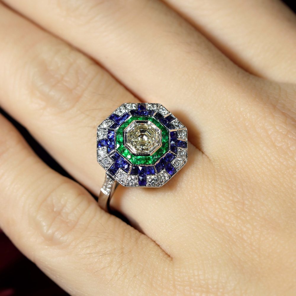 Asscher Cut Diamond Emerald Sapphire Octagonal Cluster Ring,l 1.01ct asscher-cut diamond surrounded by multiple borders of emeralds, sapphires and diamonds in 18ct white gold