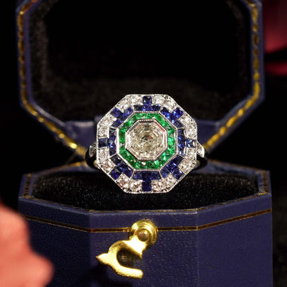 Asscher Cut Diamond Emerald Sapphire Octagonal Cluster Ring,l 1.01ct asscher-cut diamond surrounded by multiple borders of emeralds, sapphires and diamonds in 18ct white gold