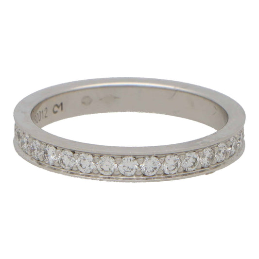 A platinum diamond full eternity band ring, on a white background