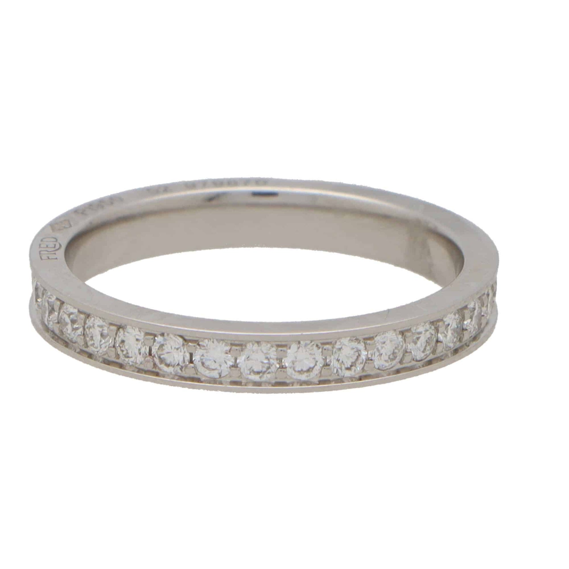 A white metal diamond set full eternity band ring, on a white background