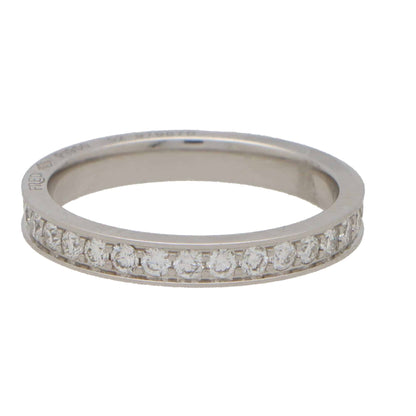 A white metal diamond set full eternity band ring, on a white background