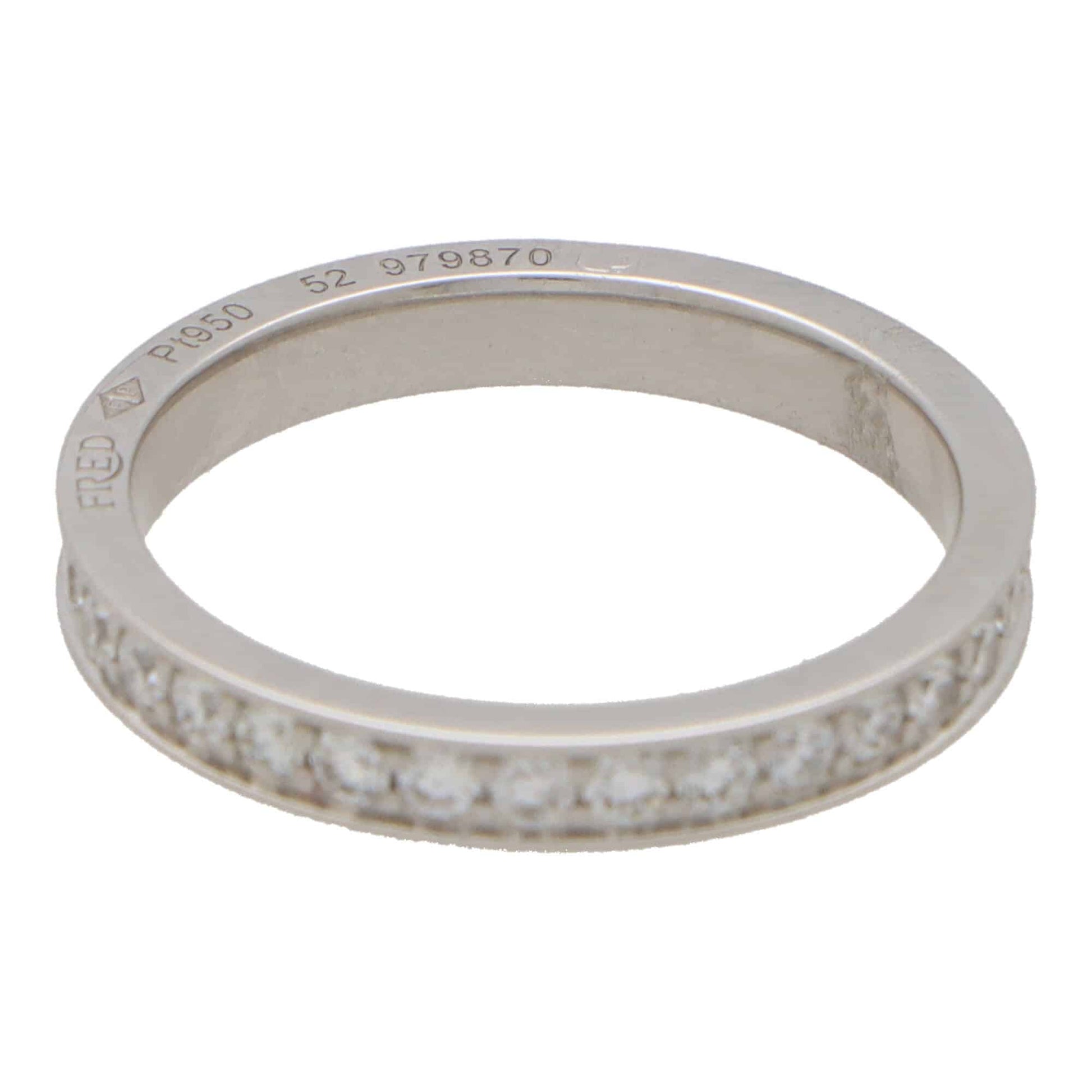 A white metal diamond set full eternity band ring stamped FRED Pt950 52 979870, on a white background