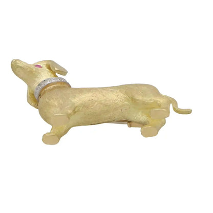 Diamond and ruby Dachshund dog brooch in gold.
