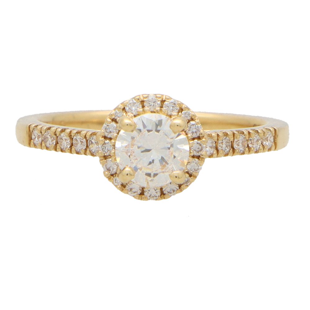 Diamond halo ring in yellow gold.