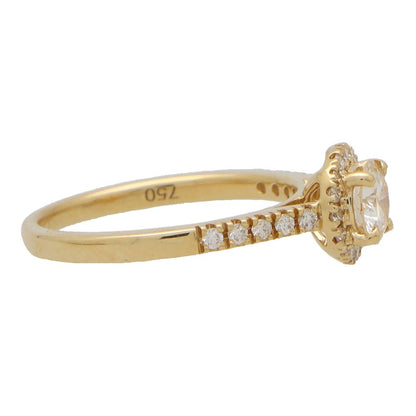 Diamond halo ring in yellow gold.