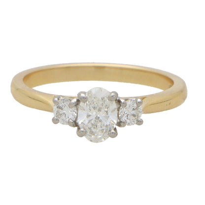 Diamond three stone ring in yellow gold and platinum.