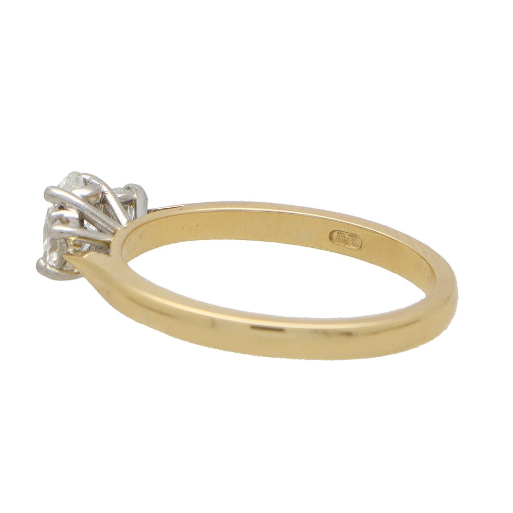 Diamond three stone ring in yellow gold and platinum.