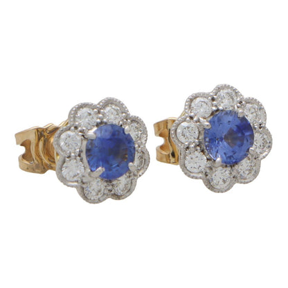 Sapphire and diamond floral cluster earrings in white and yellow gold.