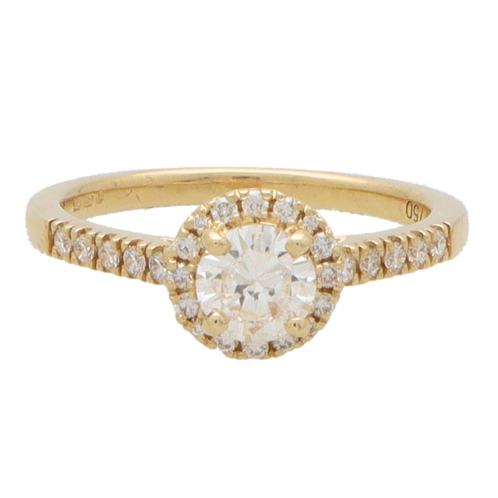 Diamond halo ring in yellow gold.