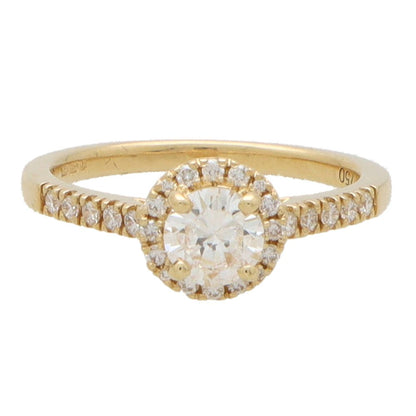 Diamond halo ring in yellow gold.