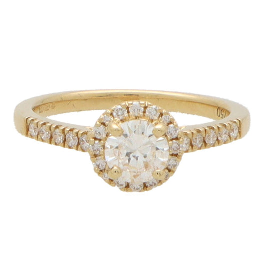 Diamond halo ring in yellow gold.