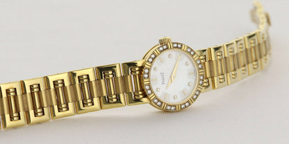 Piaget Diamond Dancer Watch in 18K Yellow Gold. Mother of pearl dial with diamond hour markers. and diamond set bezel. With Box. Quartz