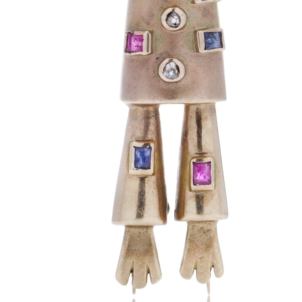 Vintage gold scarecrow brooch with gemstones.