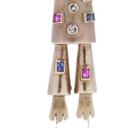 Vintage gold scarecrow brooch with gemstones.