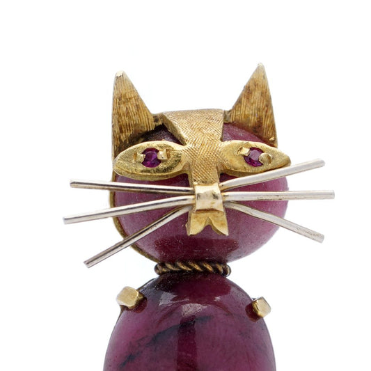 Vintage gold cat-shaped brooch with ruby eyes.