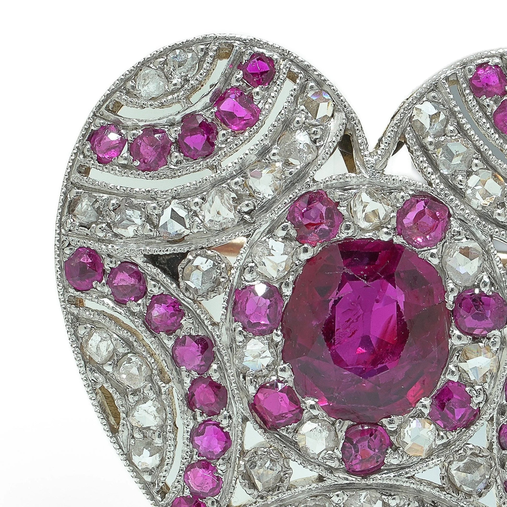 A heart shaped brooch set with rubies and diamonds, in platinum and gold