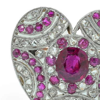 A heart shaped brooch set with rubies and diamonds, in platinum and gold