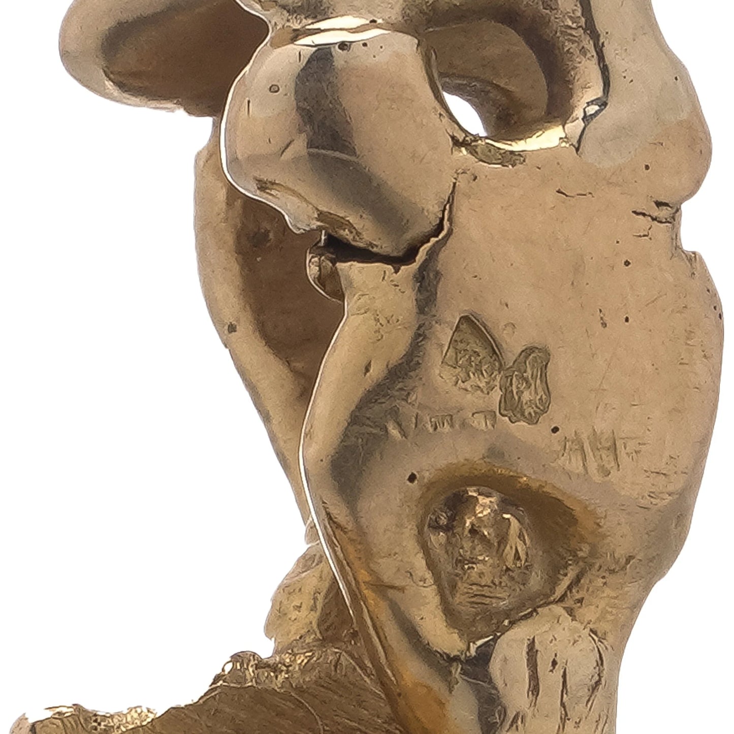 Close-up of French stamps on a yellow gold piece of jewellery