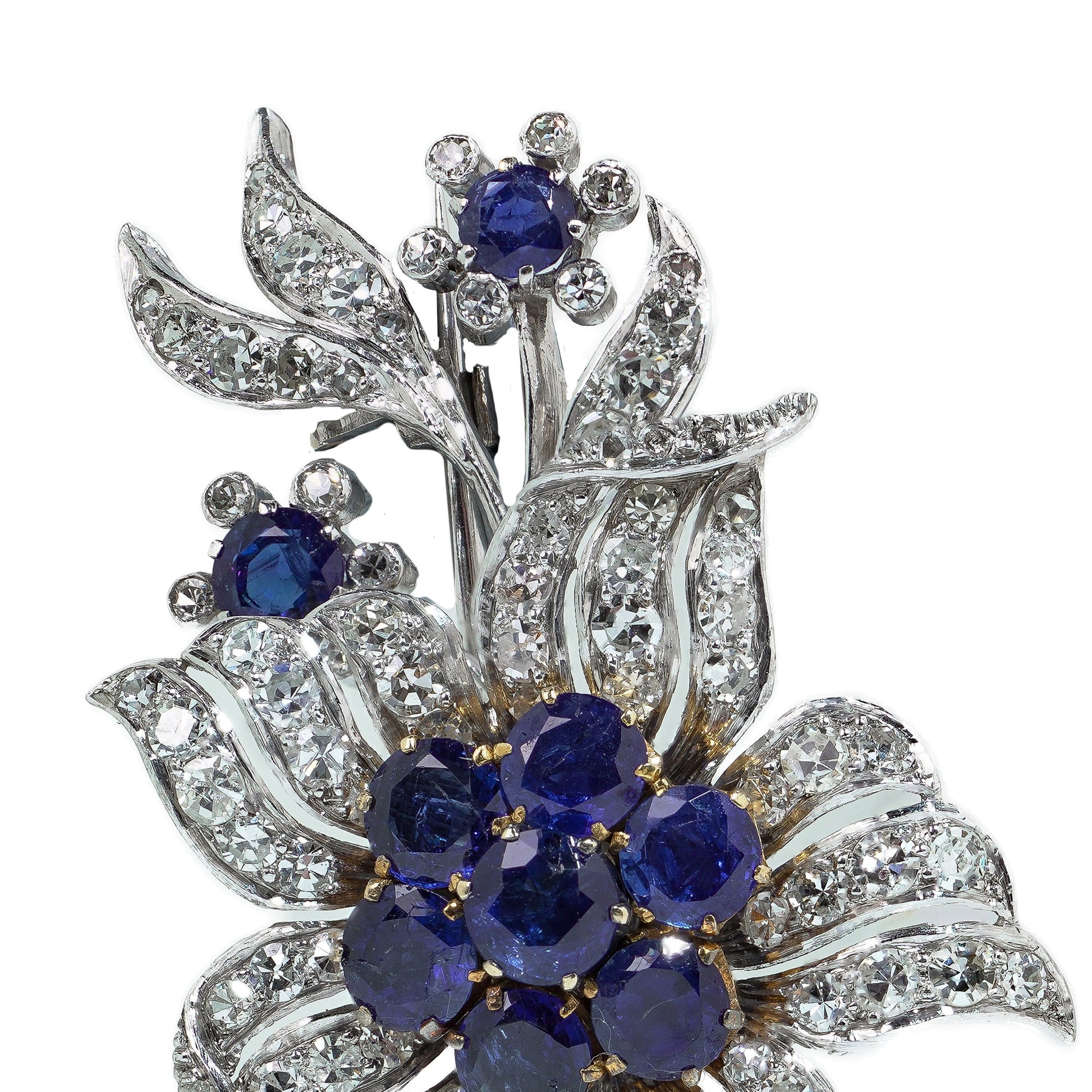 A flower spray brooch set with sapphires and diamonds, set in palladium